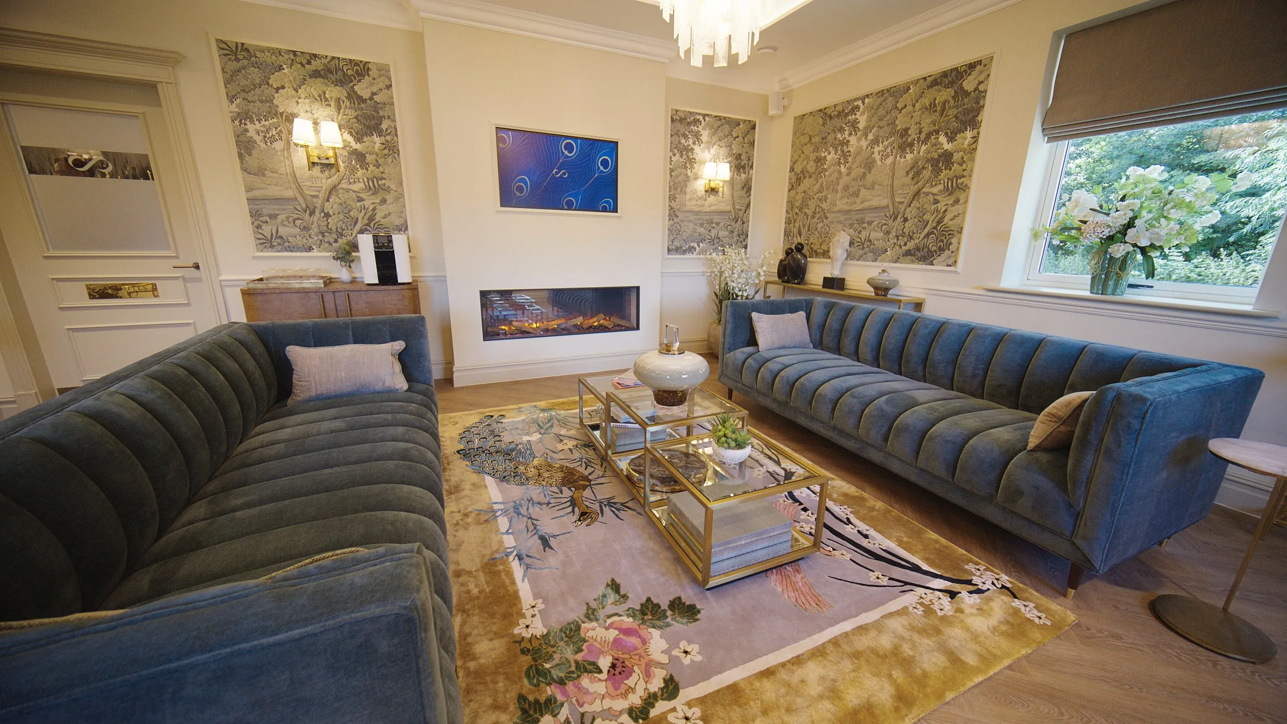 Patient lounge with navy sofas, fireplace and botanical wallpaper at Infinity Dental Suite, Harrogate