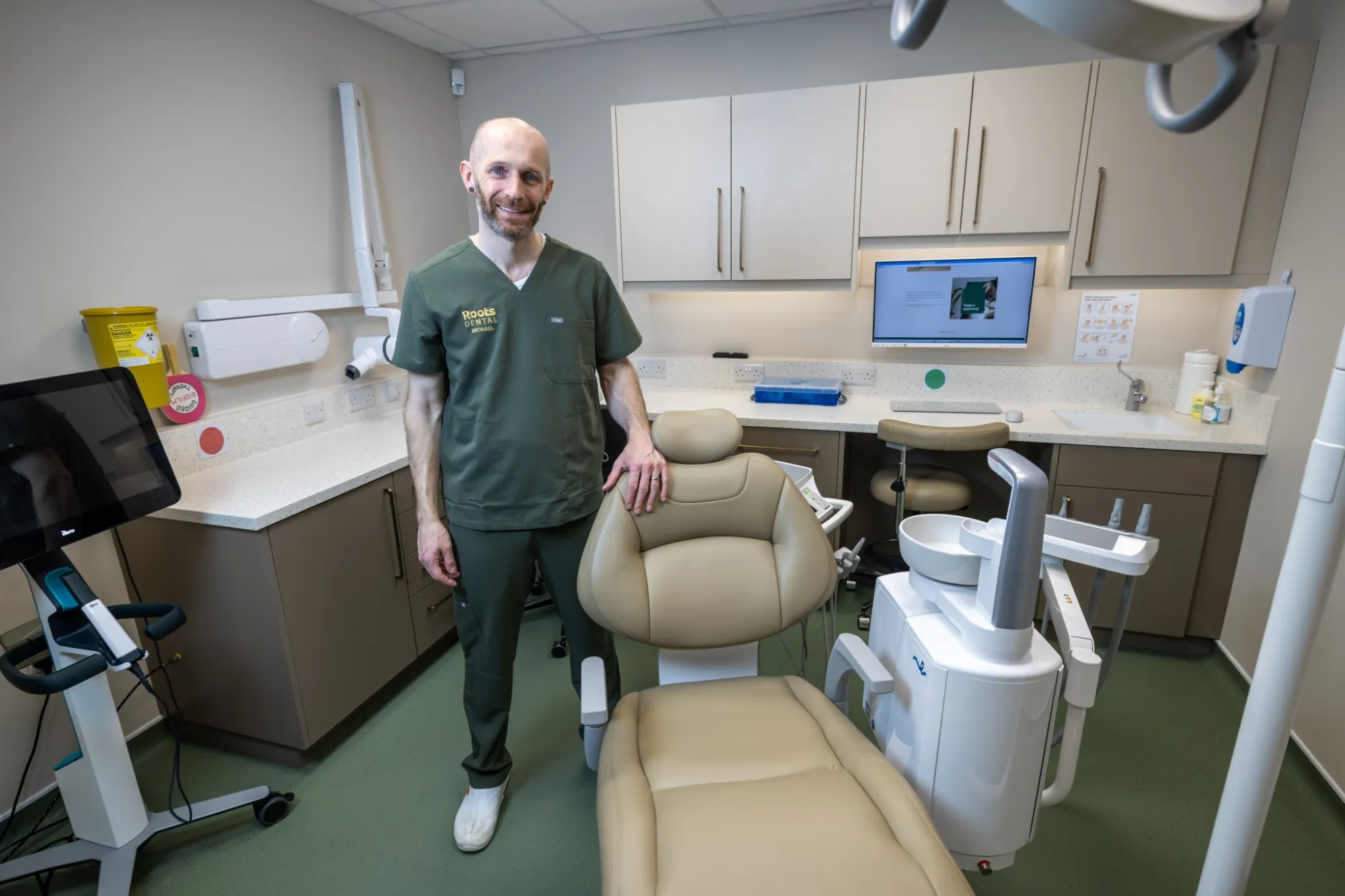 Dentist standing beside the chair in his new surgery at Roots Dental, Morpeth